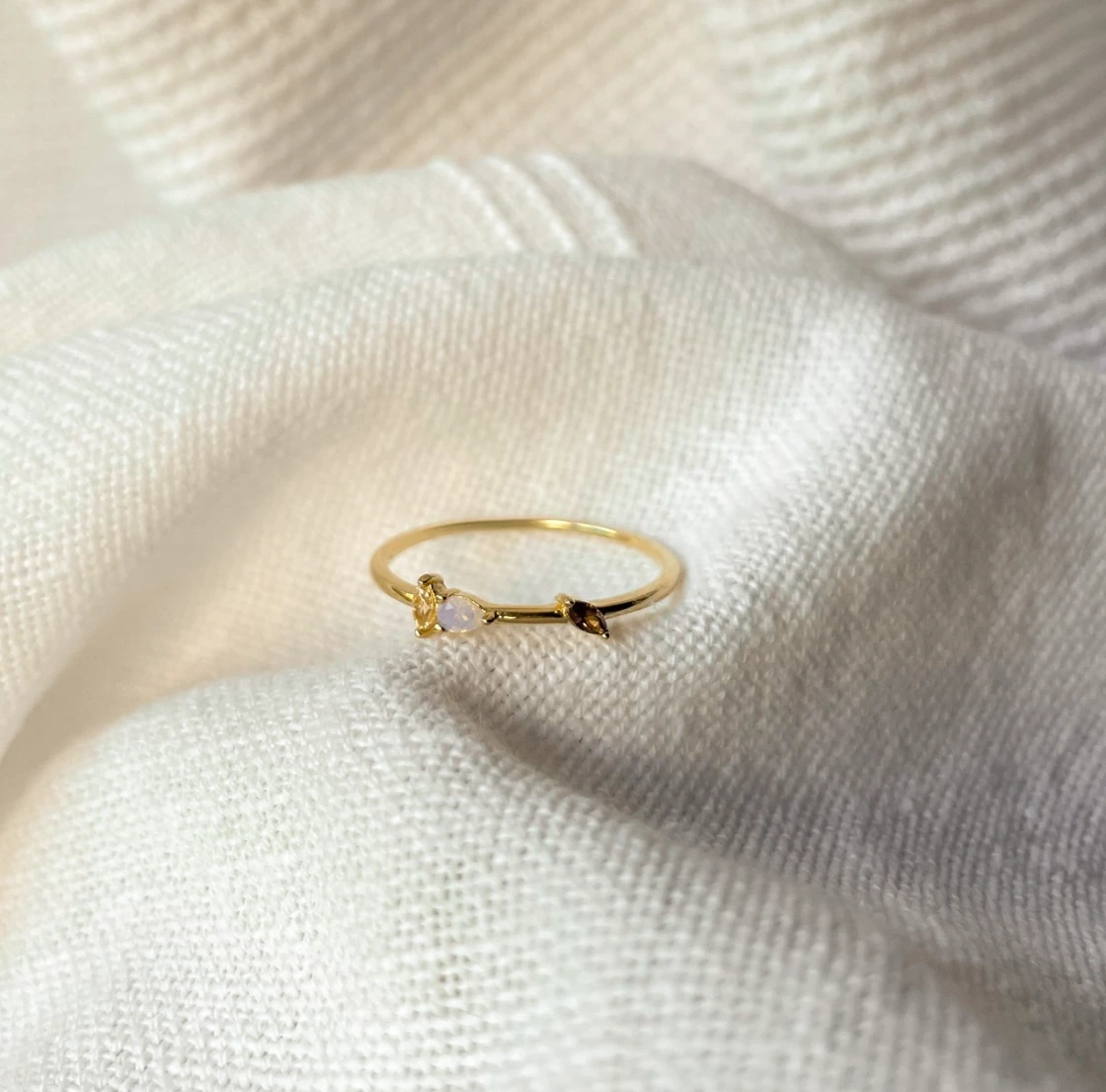 Delicate sterling silver jewellery styled on sun-washed linen